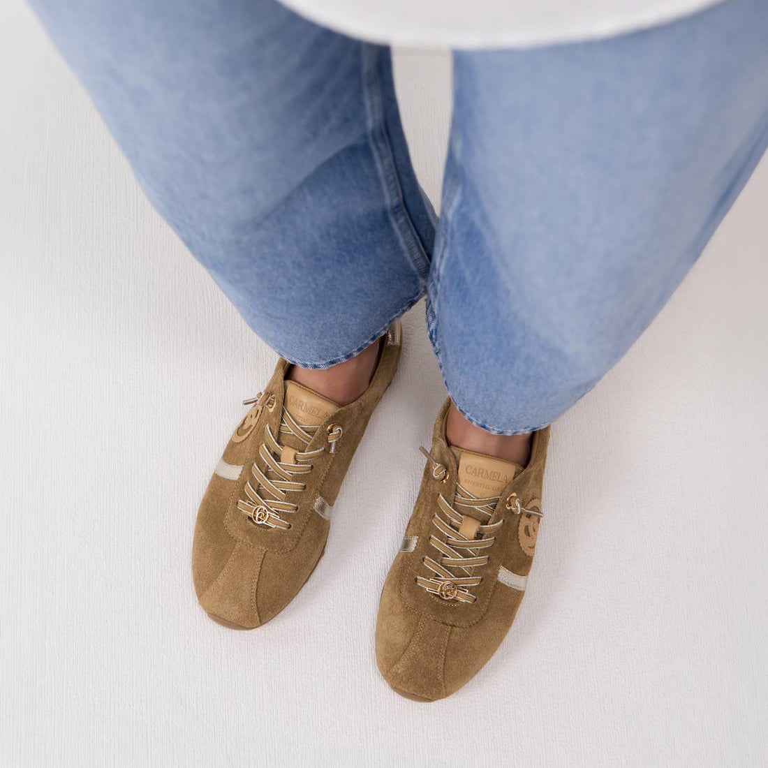 Person wearing tan suede shoes