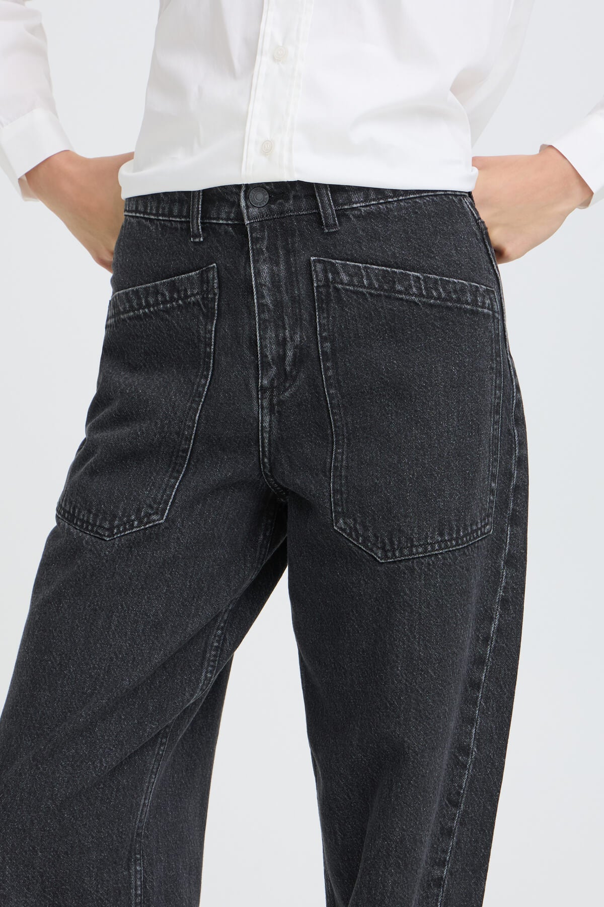 Close-up of b.young Kizion black denim jeans showing high waist, button fastening and angled patch pockets