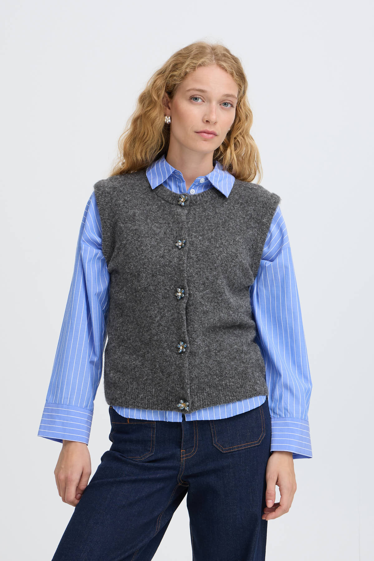 Model wearing the b.young Omea knitted vest over a striped shirt