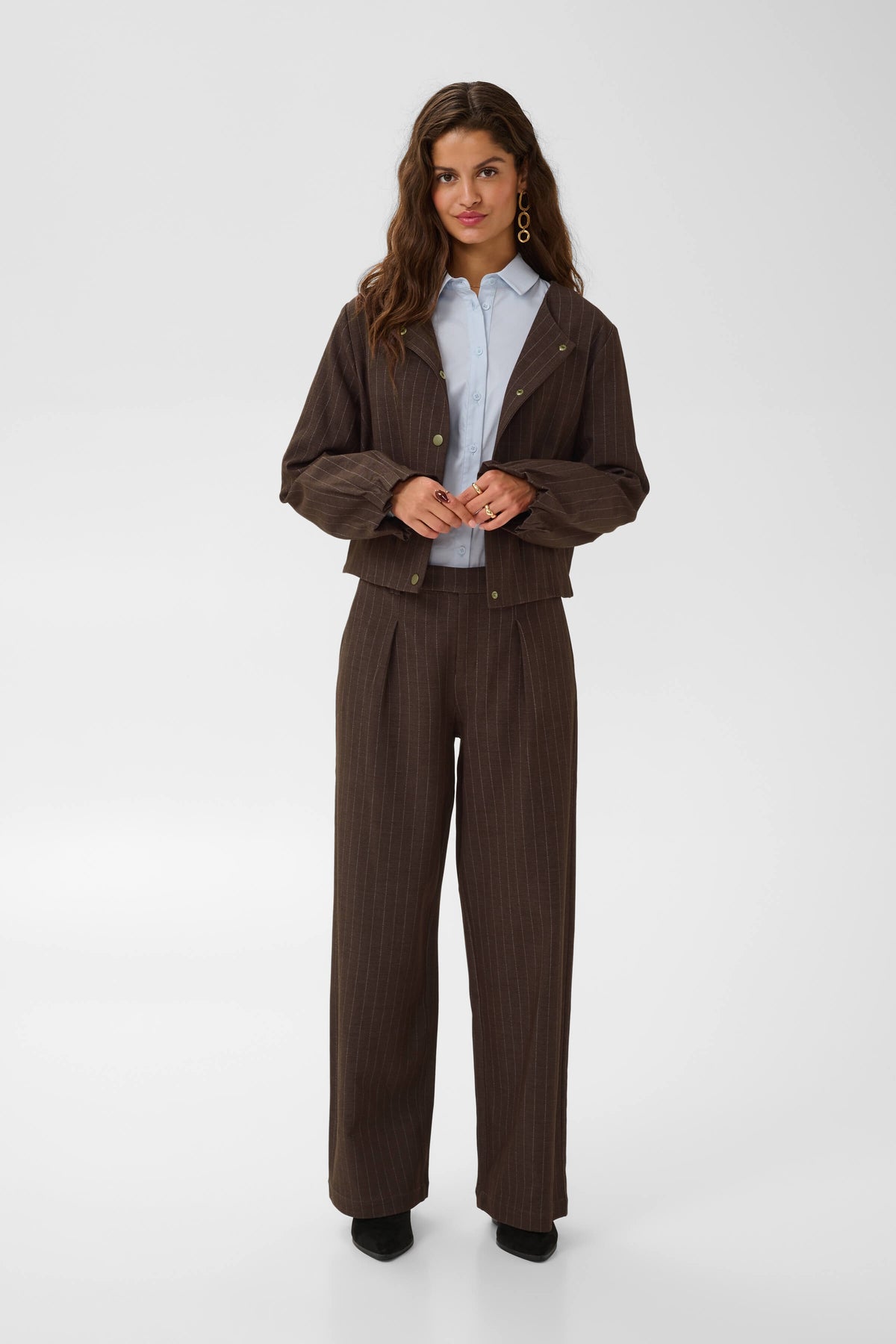 Cream wide-leg tailored trousers on model
