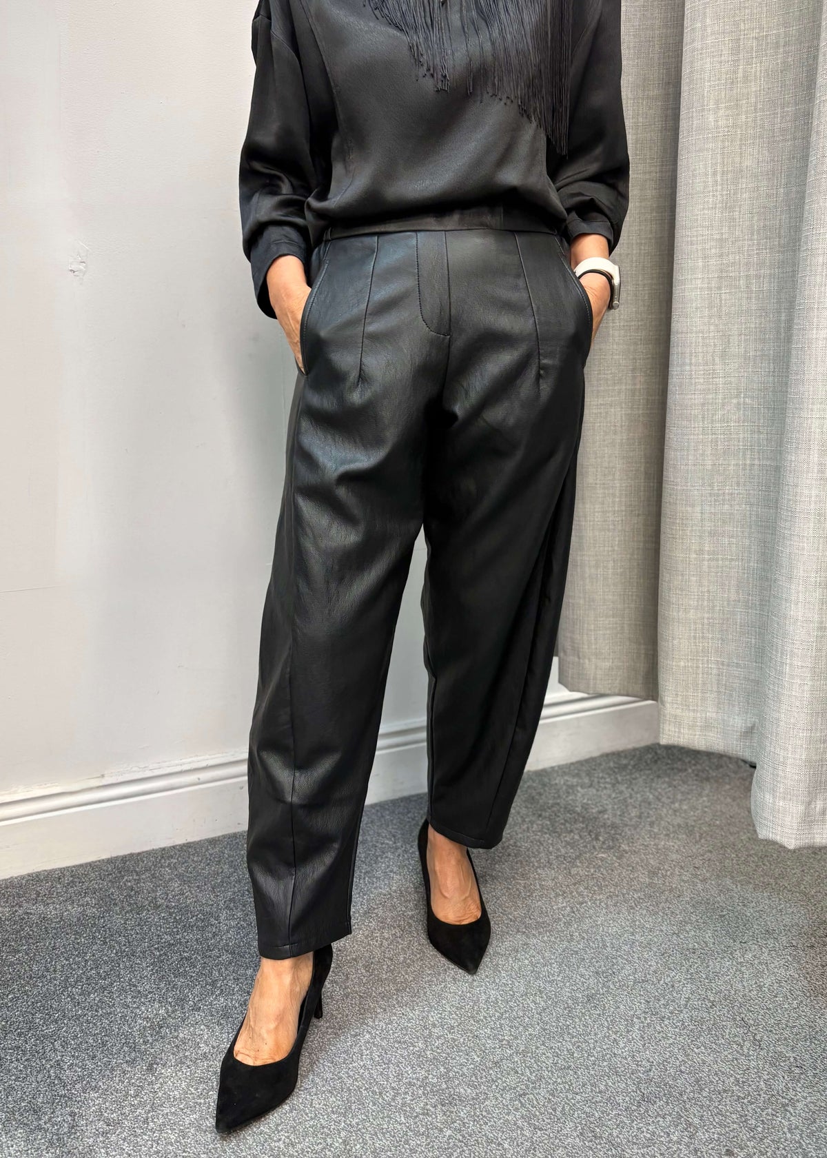 DARLING barrel-leg faux leather trousers styled with heels