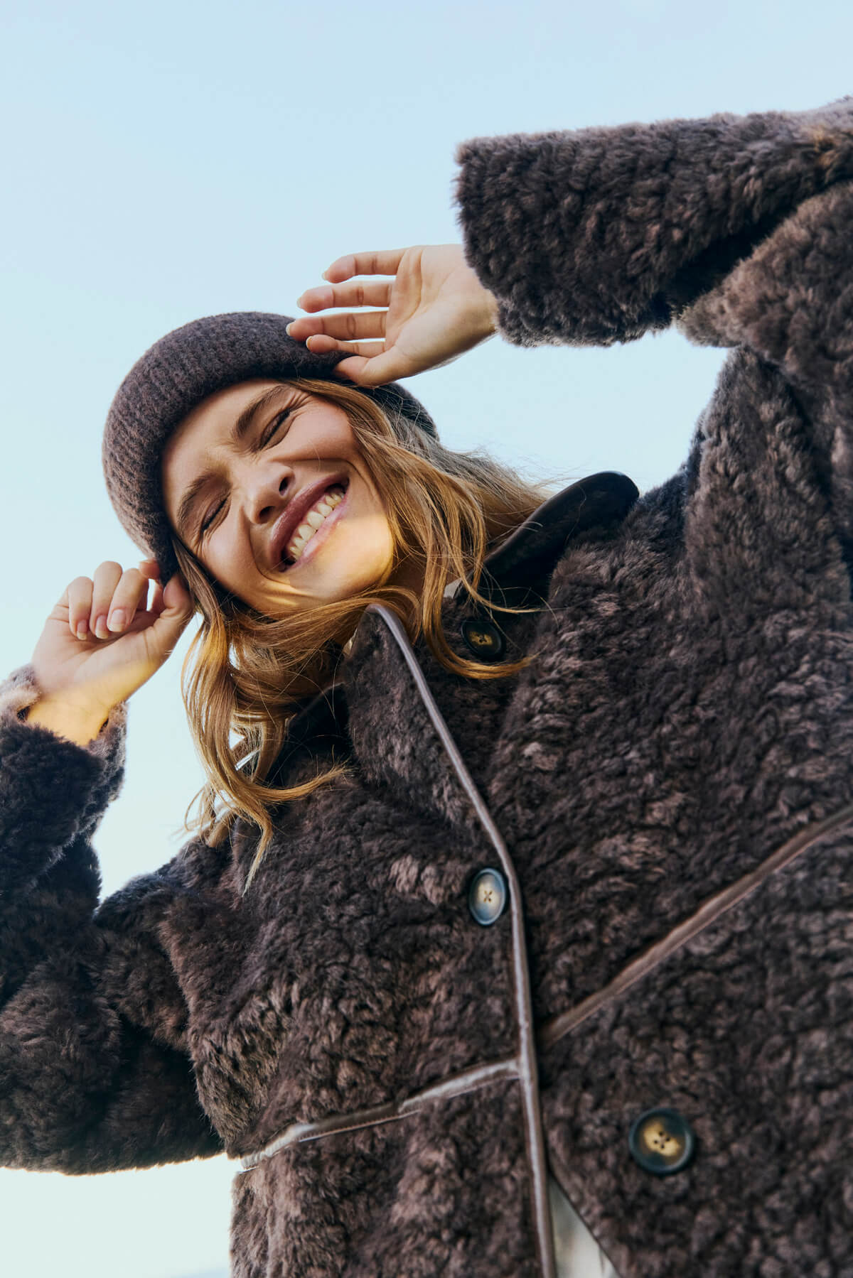 Long faux fur jacket with a classic collar and button fastening
