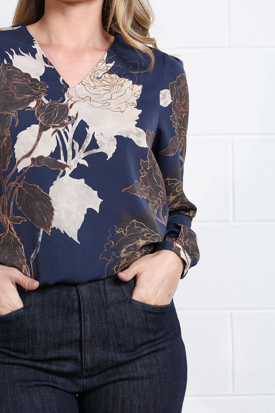Close-up of the Mia Blouse’s large floral print and flowing fabric