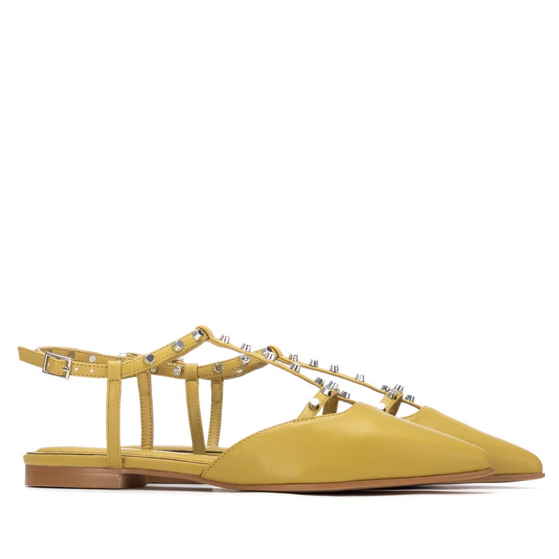A pair of yellow flats with studded t-bar