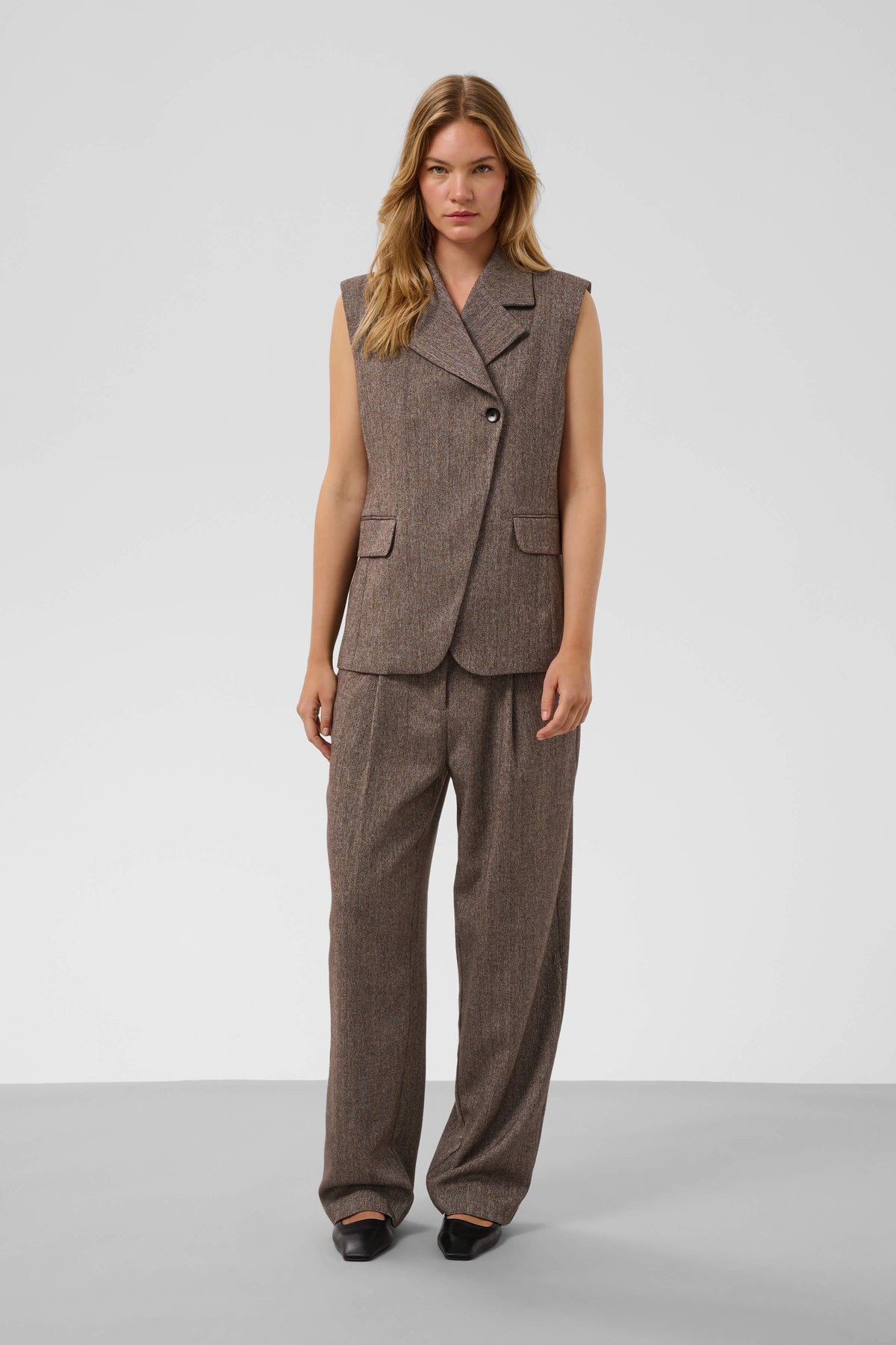 Model wearing Kango Trousers with the coordinating tailored waistcoat
