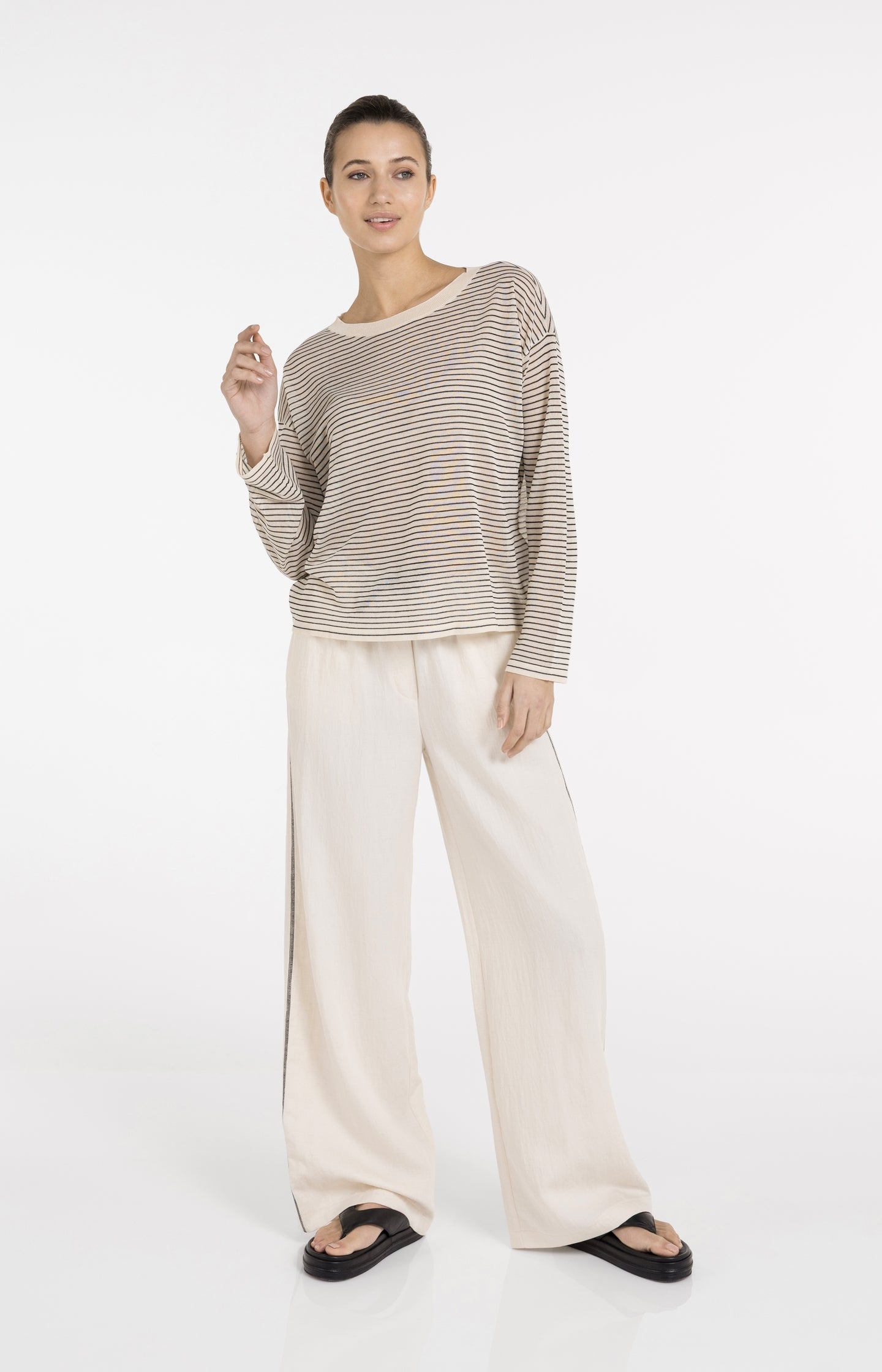 Cream trousers with wide legs and contrast stitching