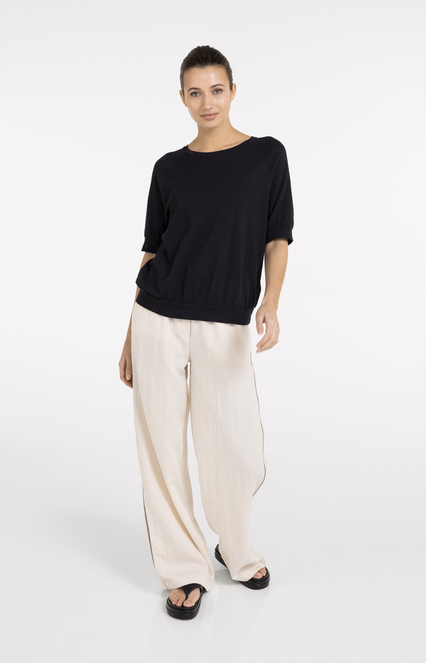 Cream trousers with black stitching