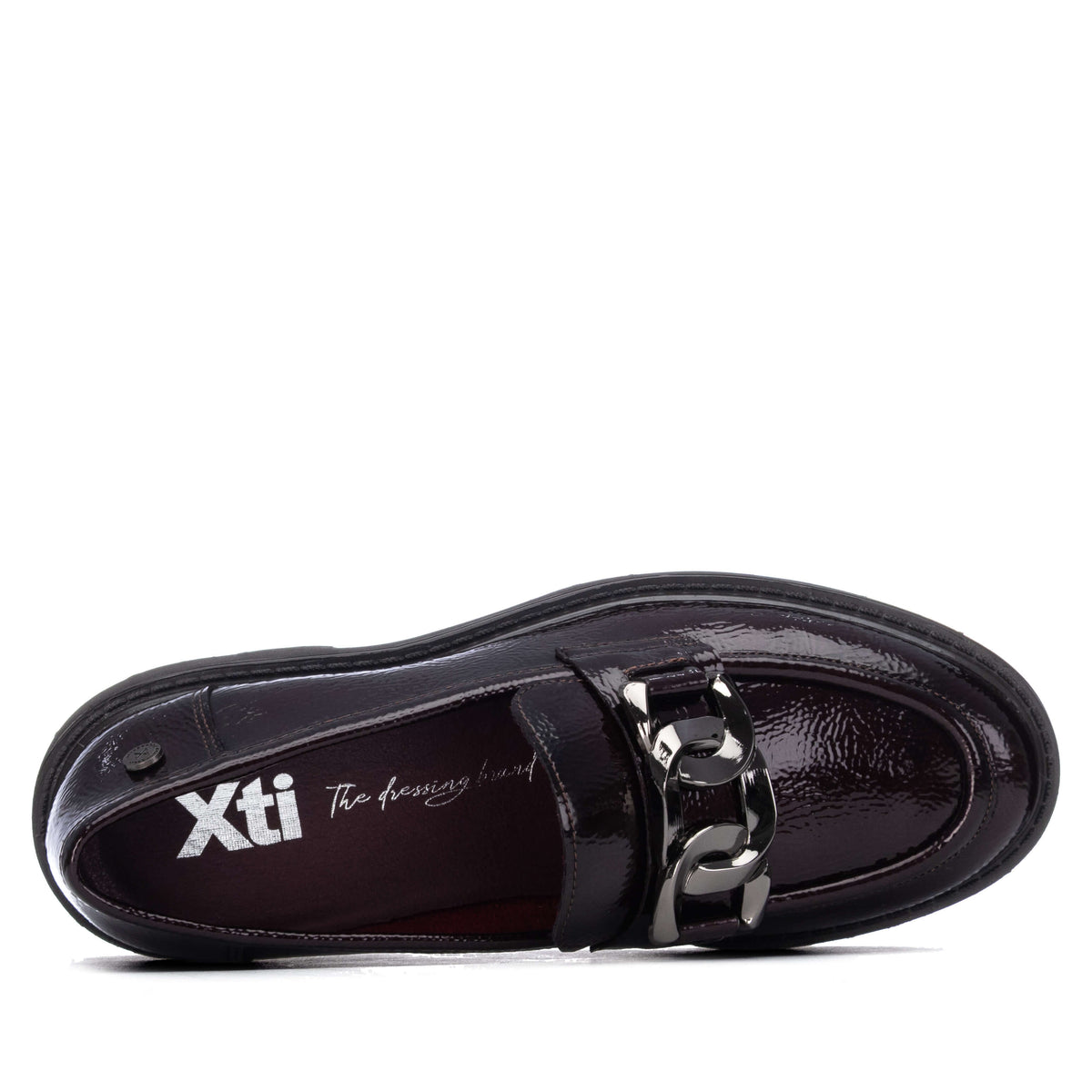 A single black patent leather loafer across the vamp and the brand name 'Xti' printed on the insole.