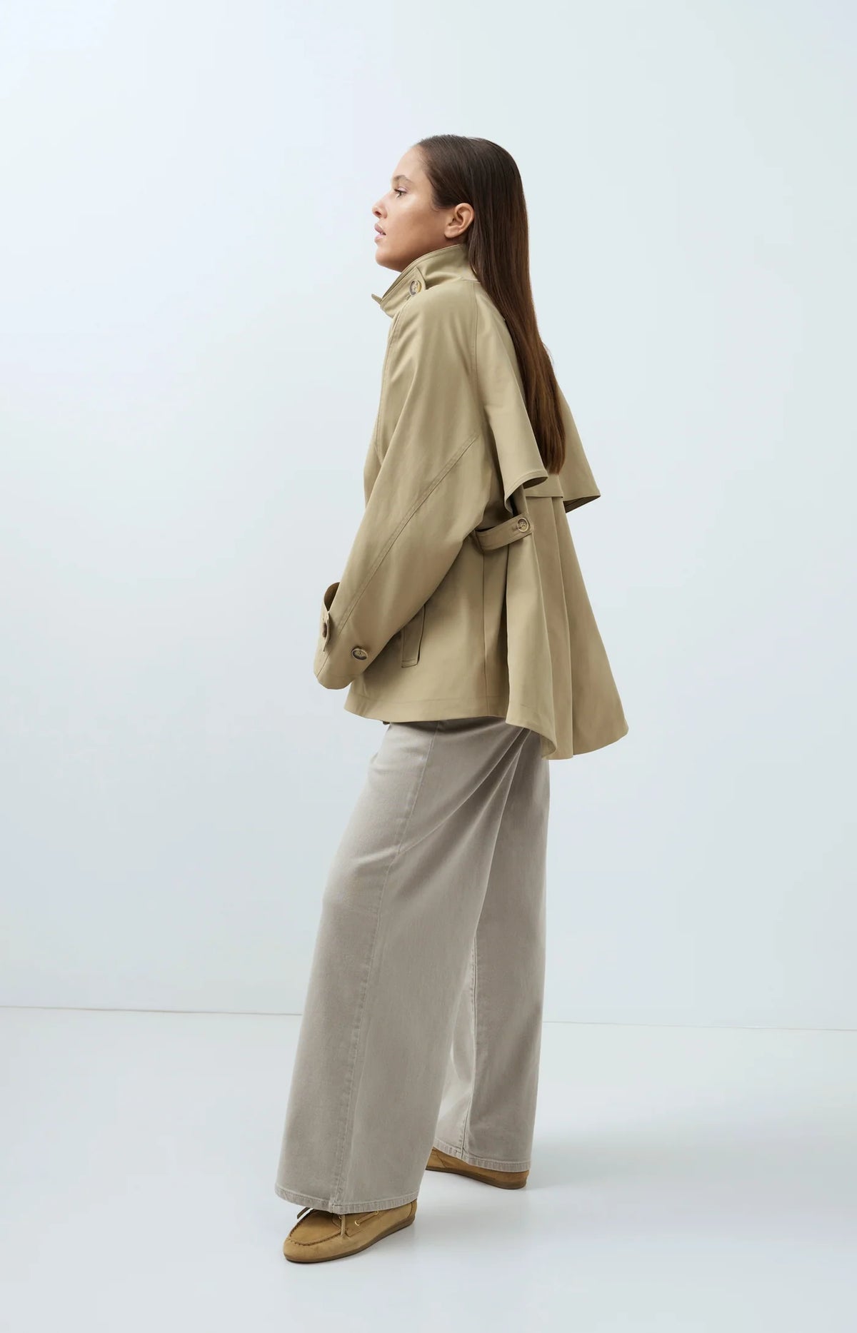 Side view of YAYA trench jacket with cape detail