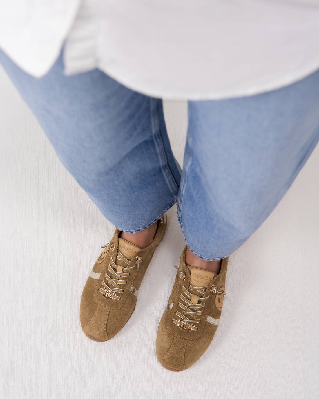 Person wearing tan suede shoes 