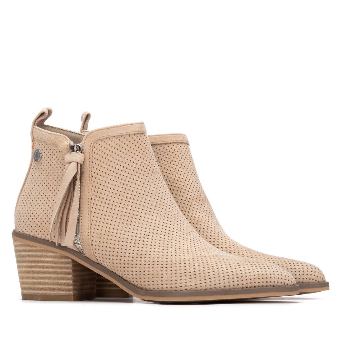 A pair of ankle boots with decorative zip at the side