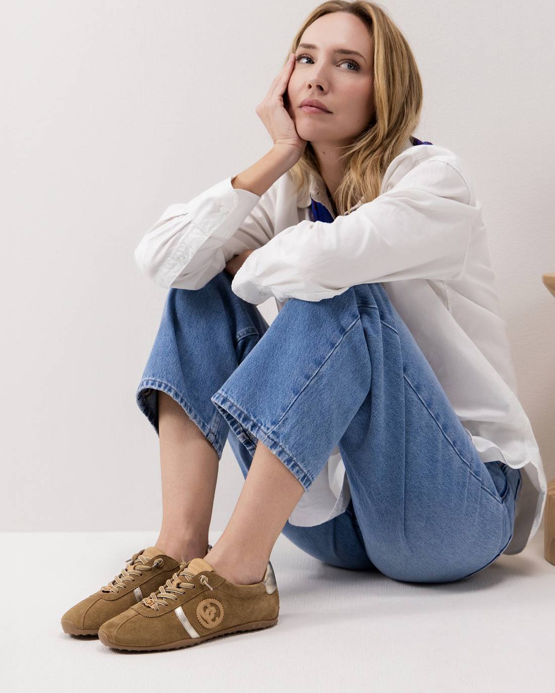 Woman weaking brown suede flat runners