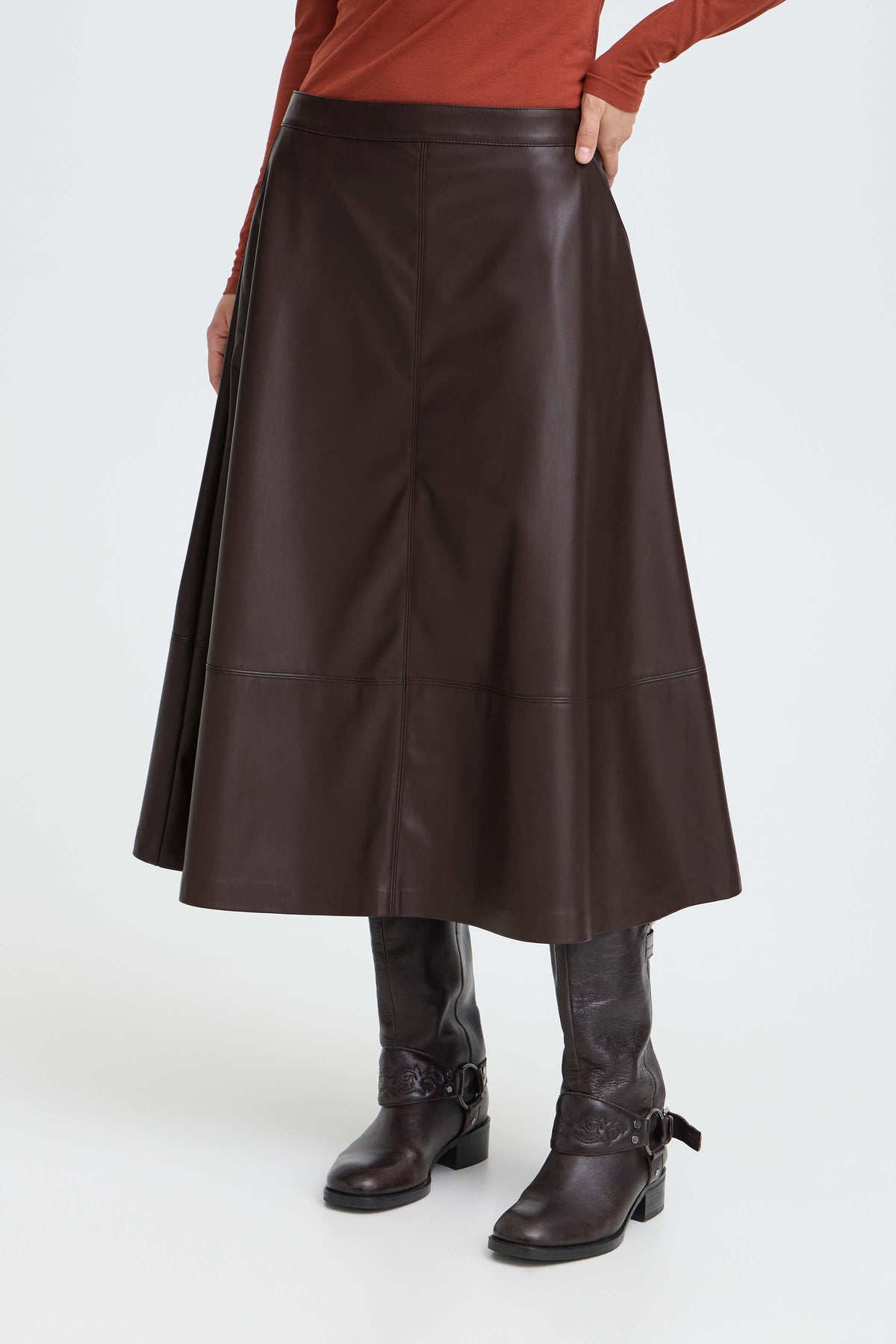 Model wearing the b.young Daja brown leather-look A-line midi skirt with a mid-rise waistband