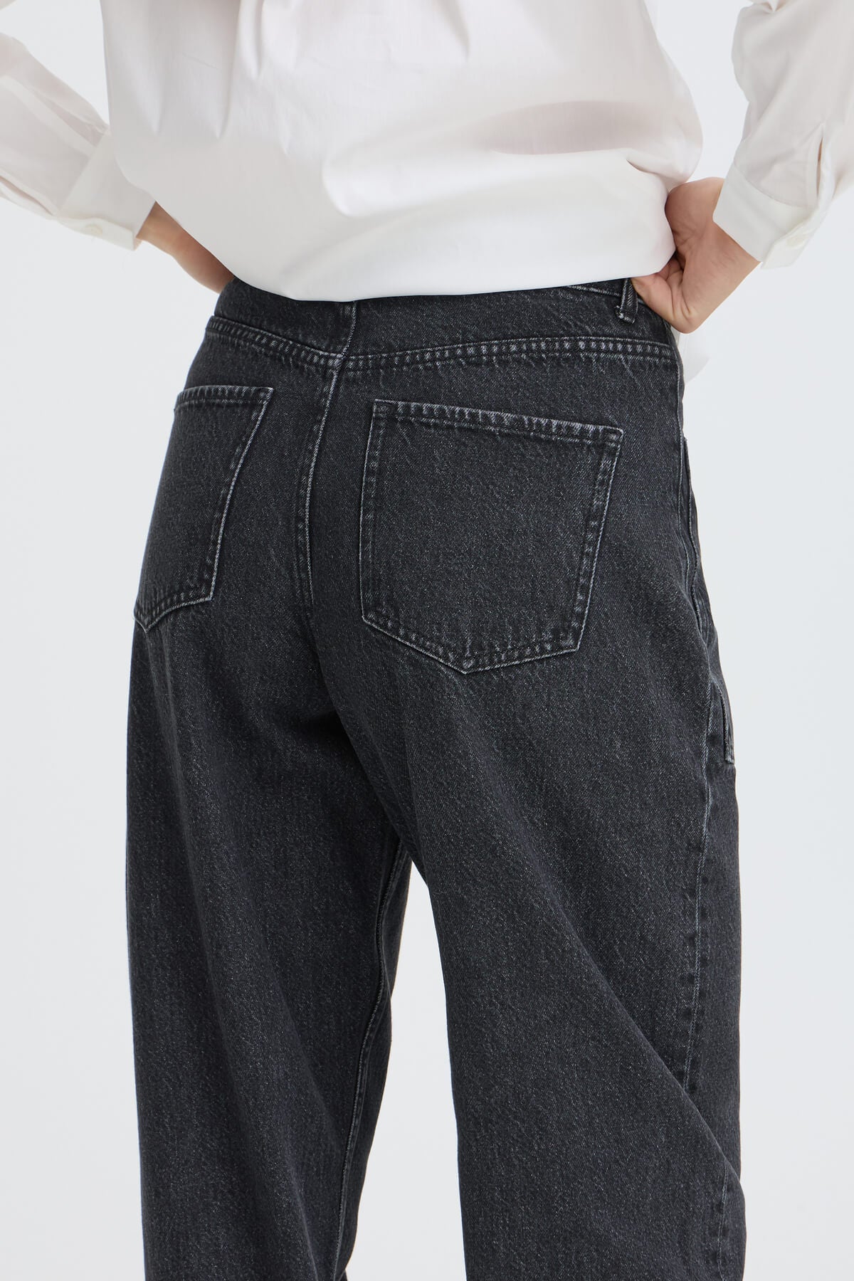 Close-up back view of b.young Kizion jeans showing rear patch pockets and visible seams