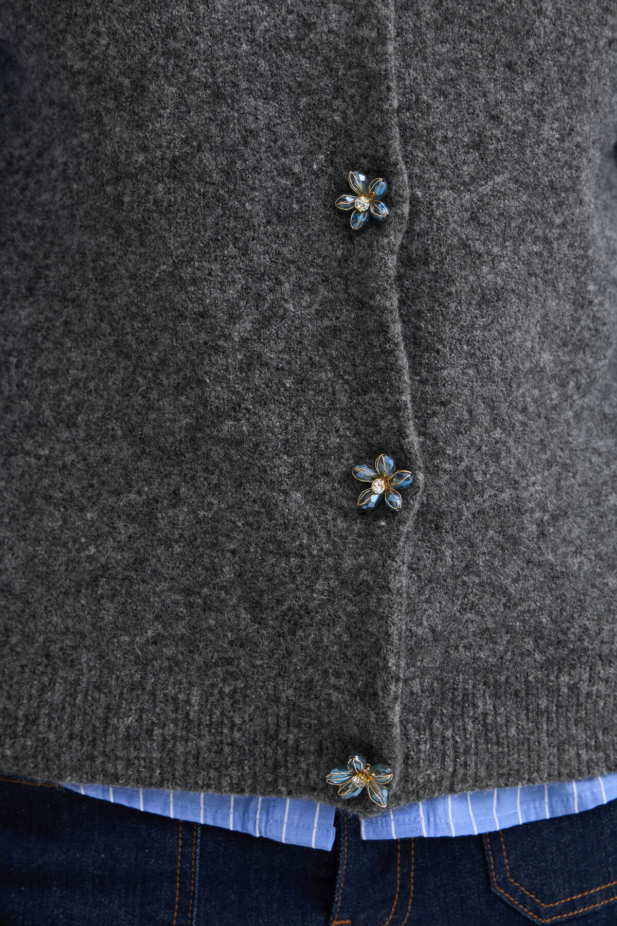 Close-up of the b.young Omea vest showing its soft texture and decorative floral button front