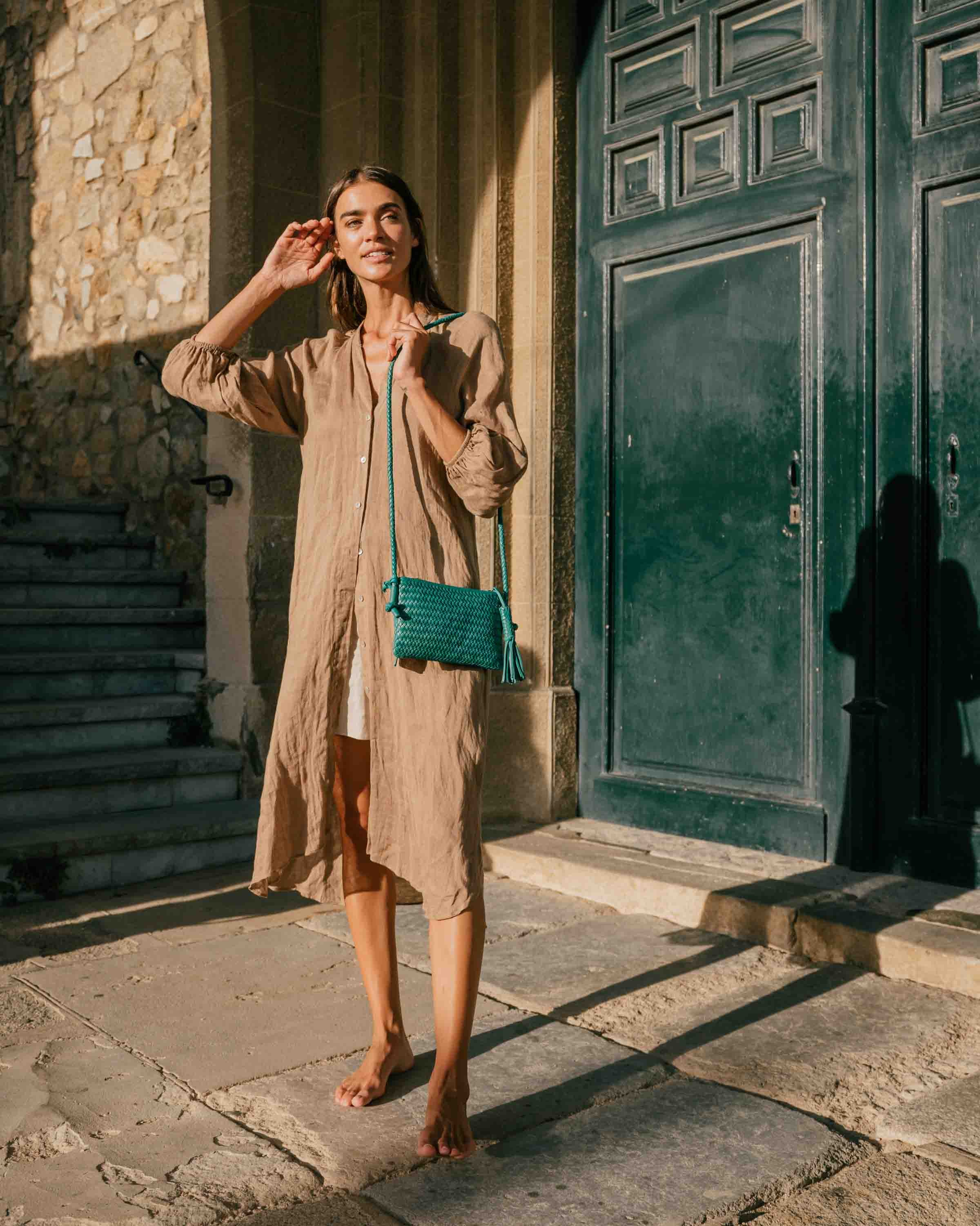 Woman wearing a green leather handbag 