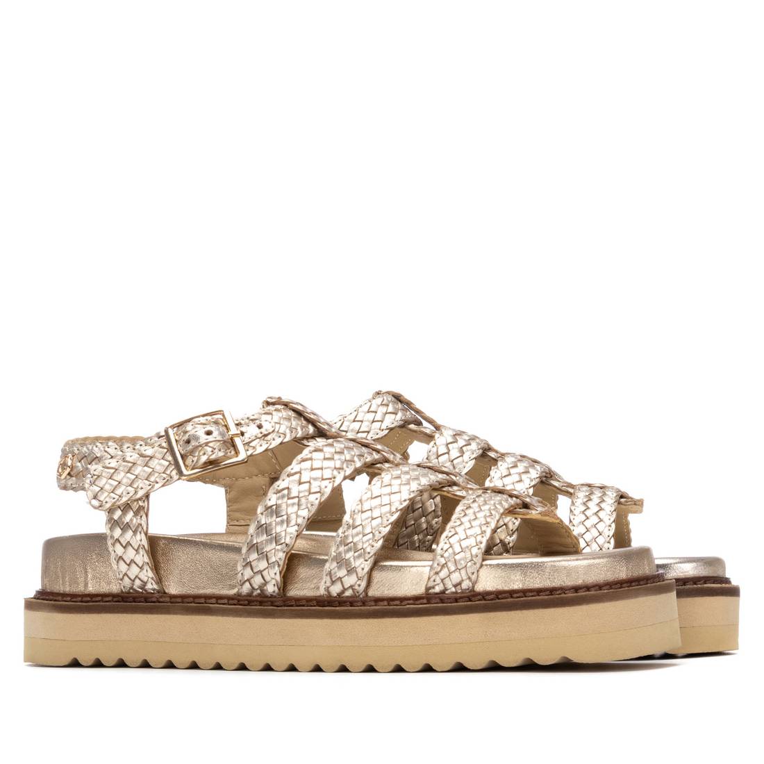 A pair of gold summer sandals on a chunky sole