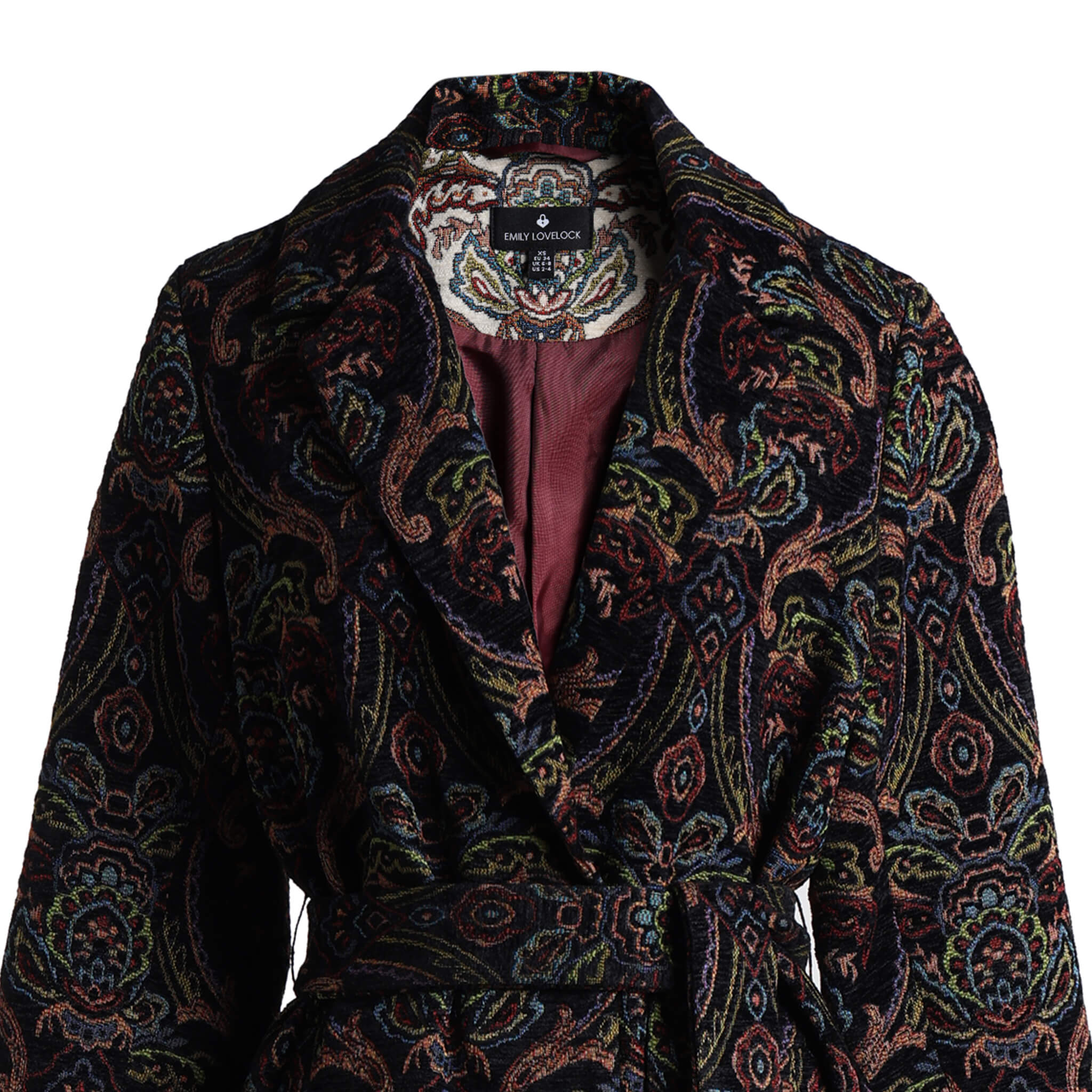 Close-up of Emily Lovelock Deborah coat with wide lapels and burgundy lining
