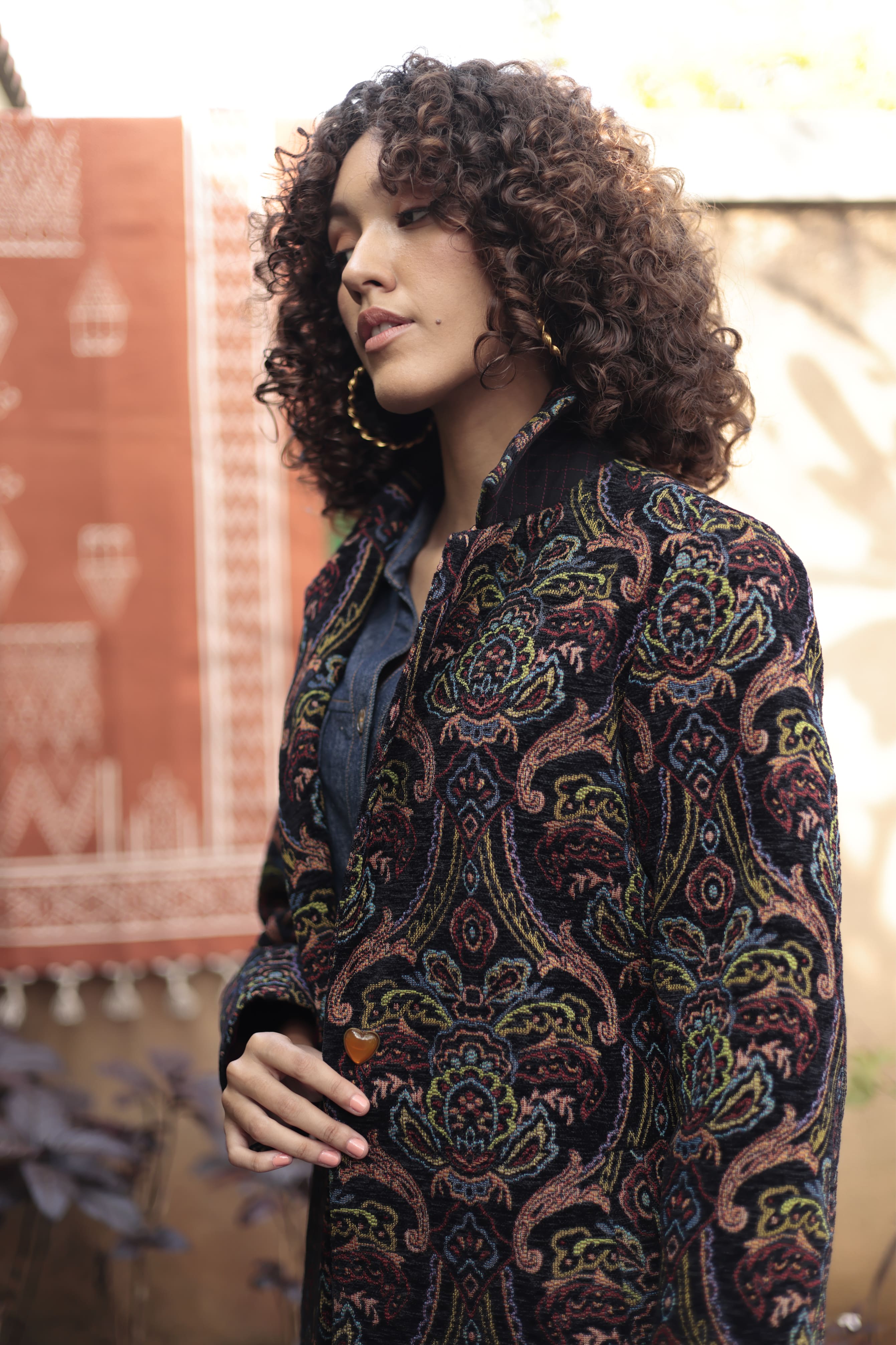 Close-up of model wearing the Emily Lovelock Deborah coat with heart-shaped button