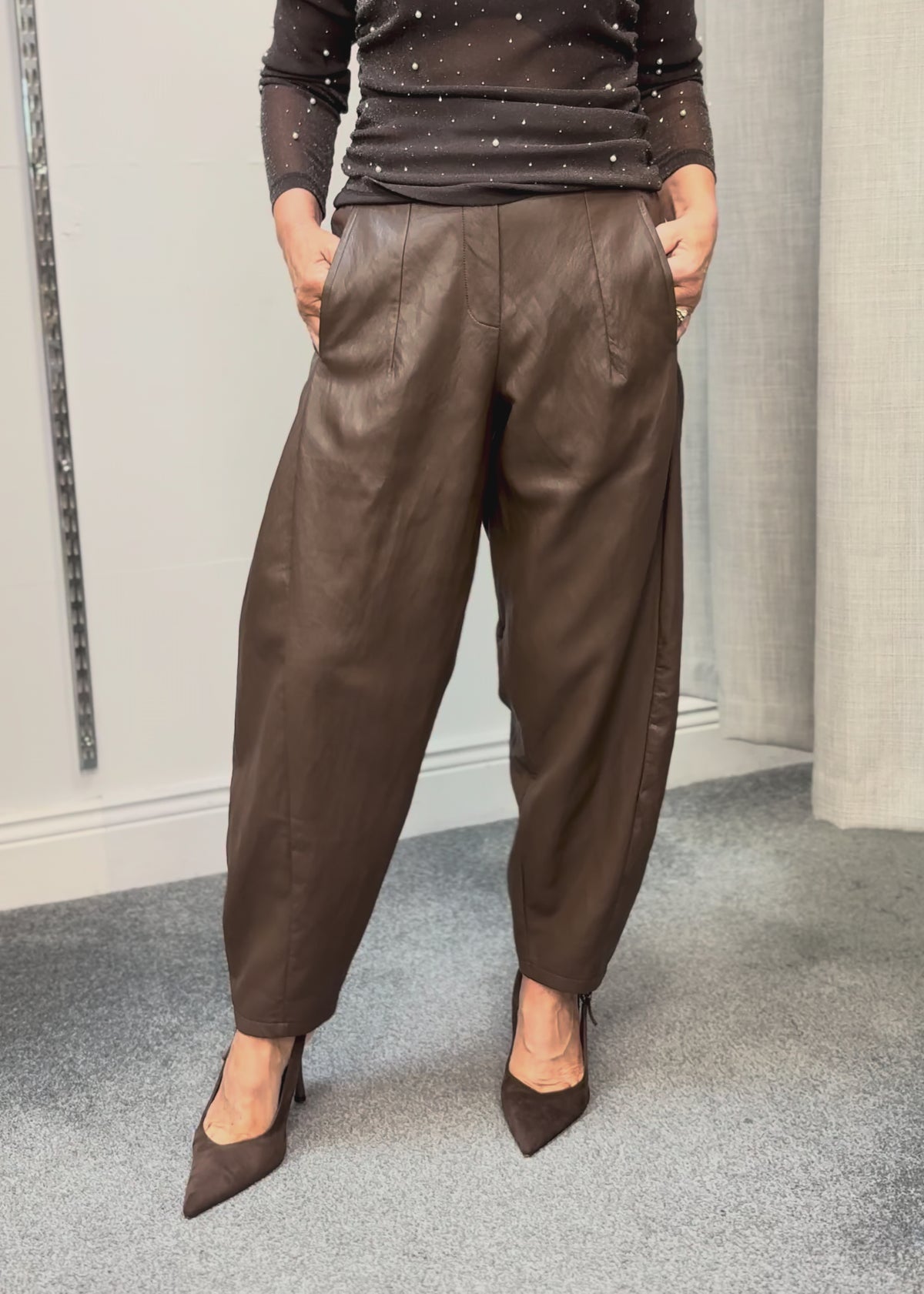 DARLING barrel-leg faux leather trousers styled with heels