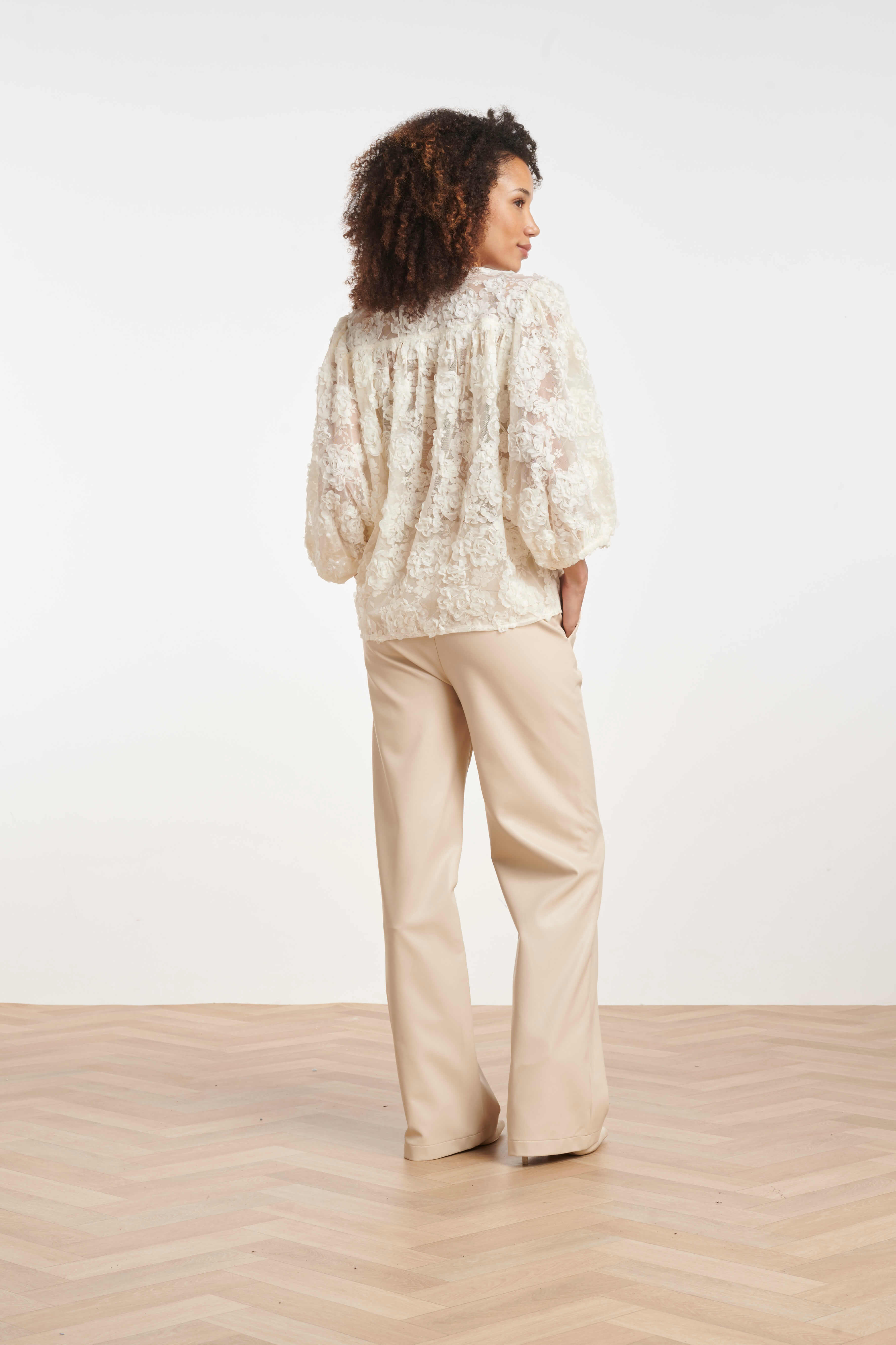 Back view of the Smashed Lemon faux-leather trousers