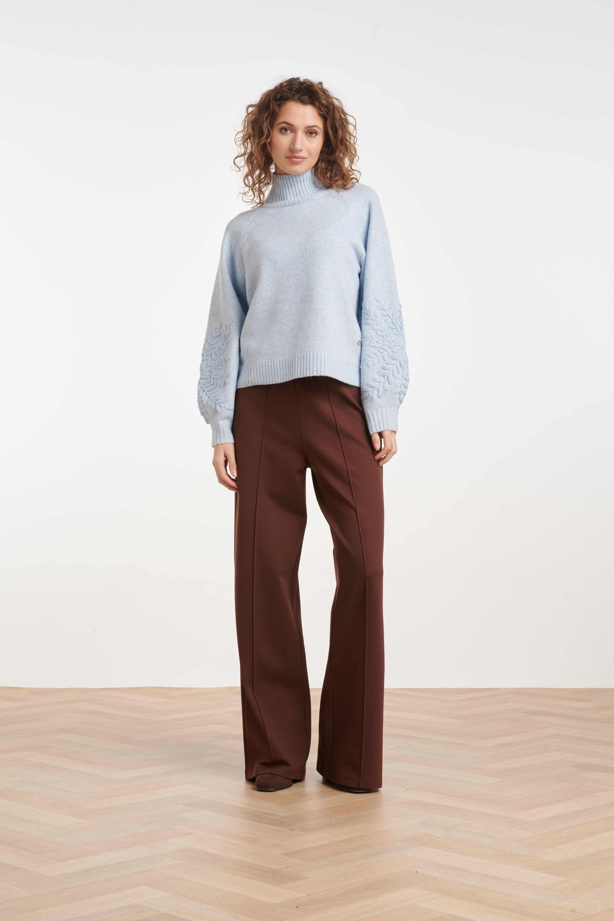 Women’s roll-neck knit with raglan shoulders and ribbed trims