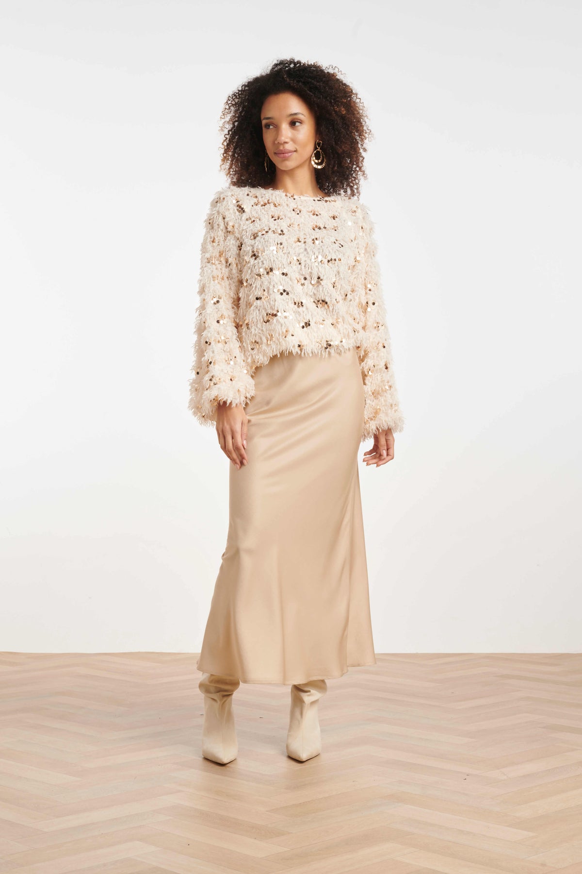 Women’s statement top with feathered texture and scattered sequins