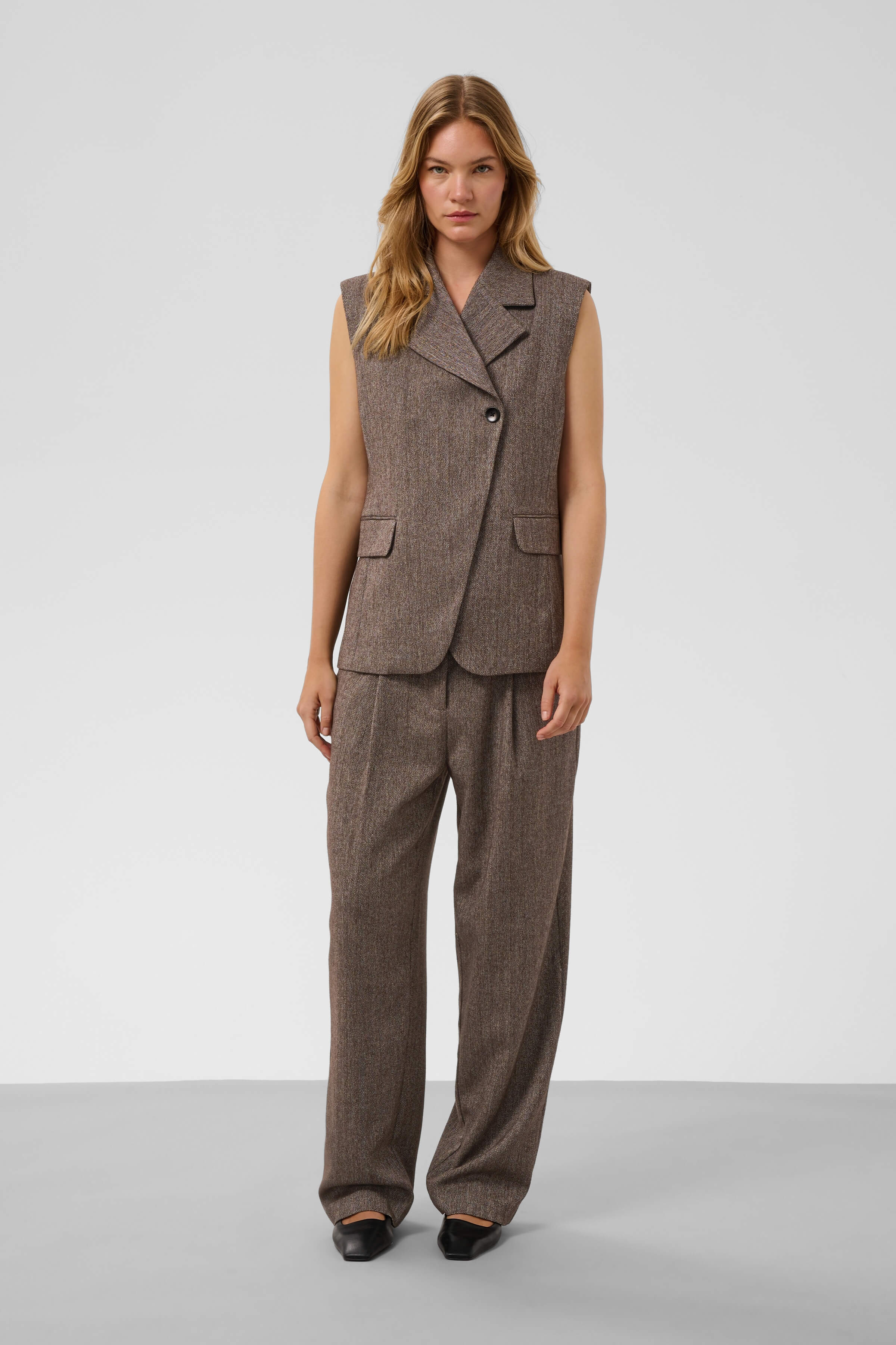Model wearing Kango Trousers with the coordinating tailored waistcoat