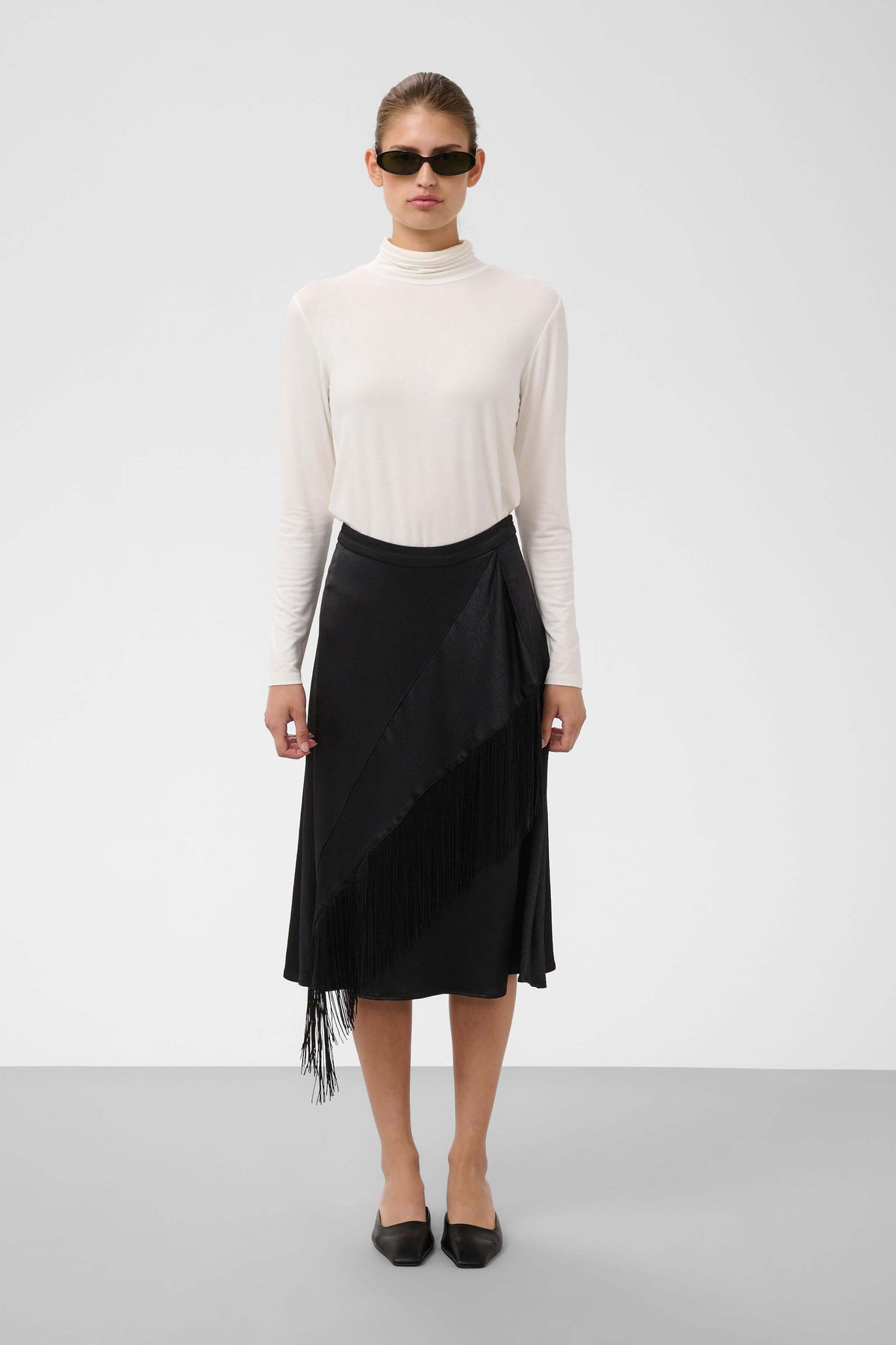 Model wearing the Soaked in Luxury Mirabella fringed skirt