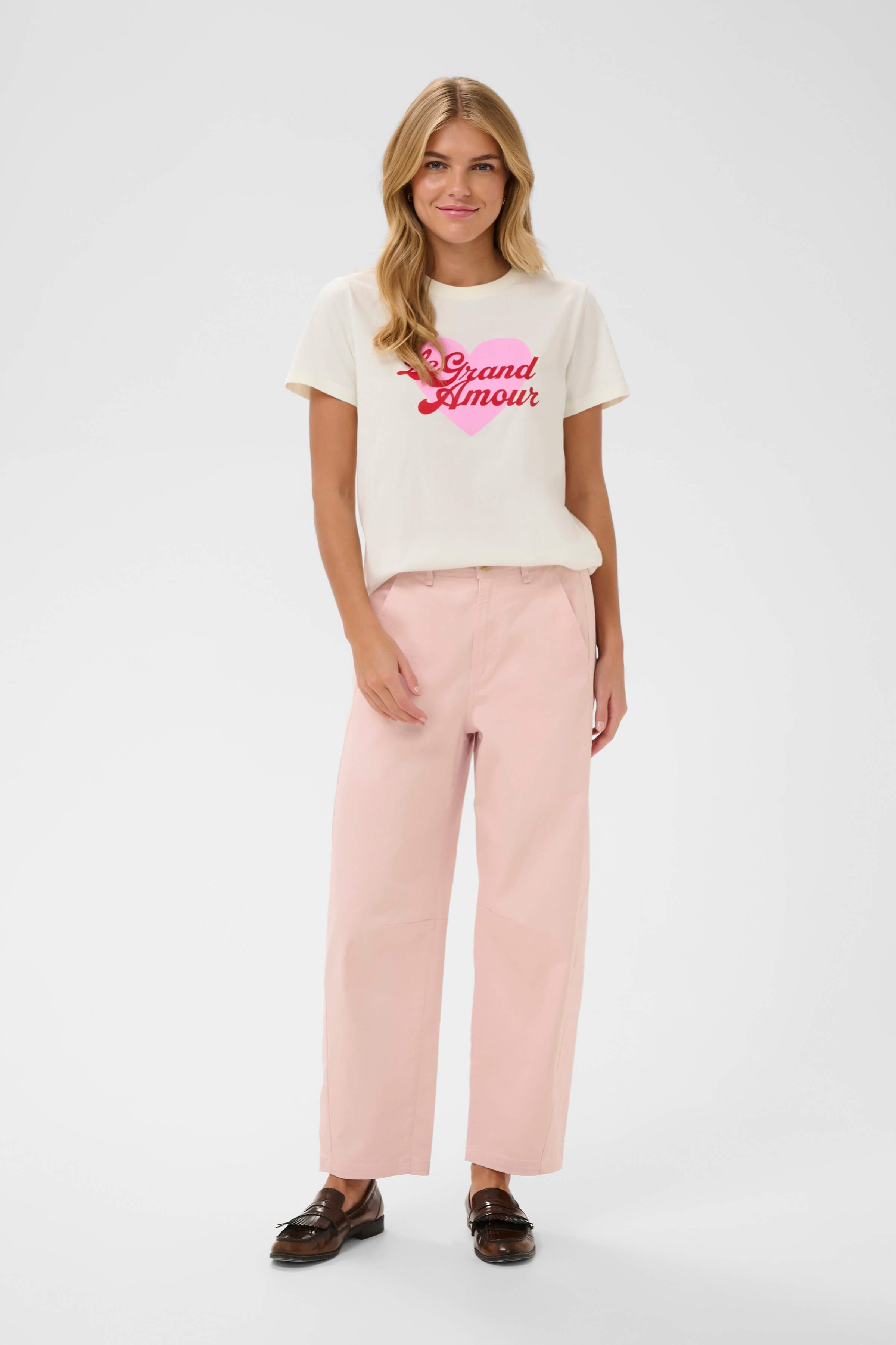 An outfit with a pair of pink barrel-leg jeans