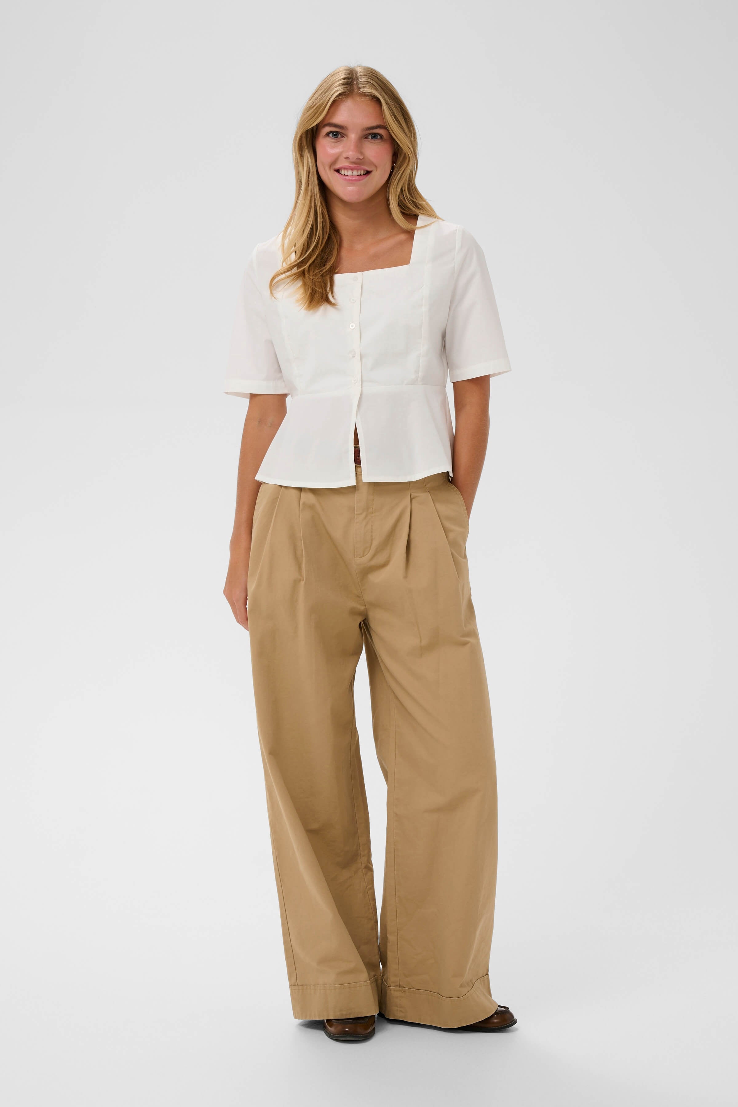 An outfit with a white blouse with square neckline