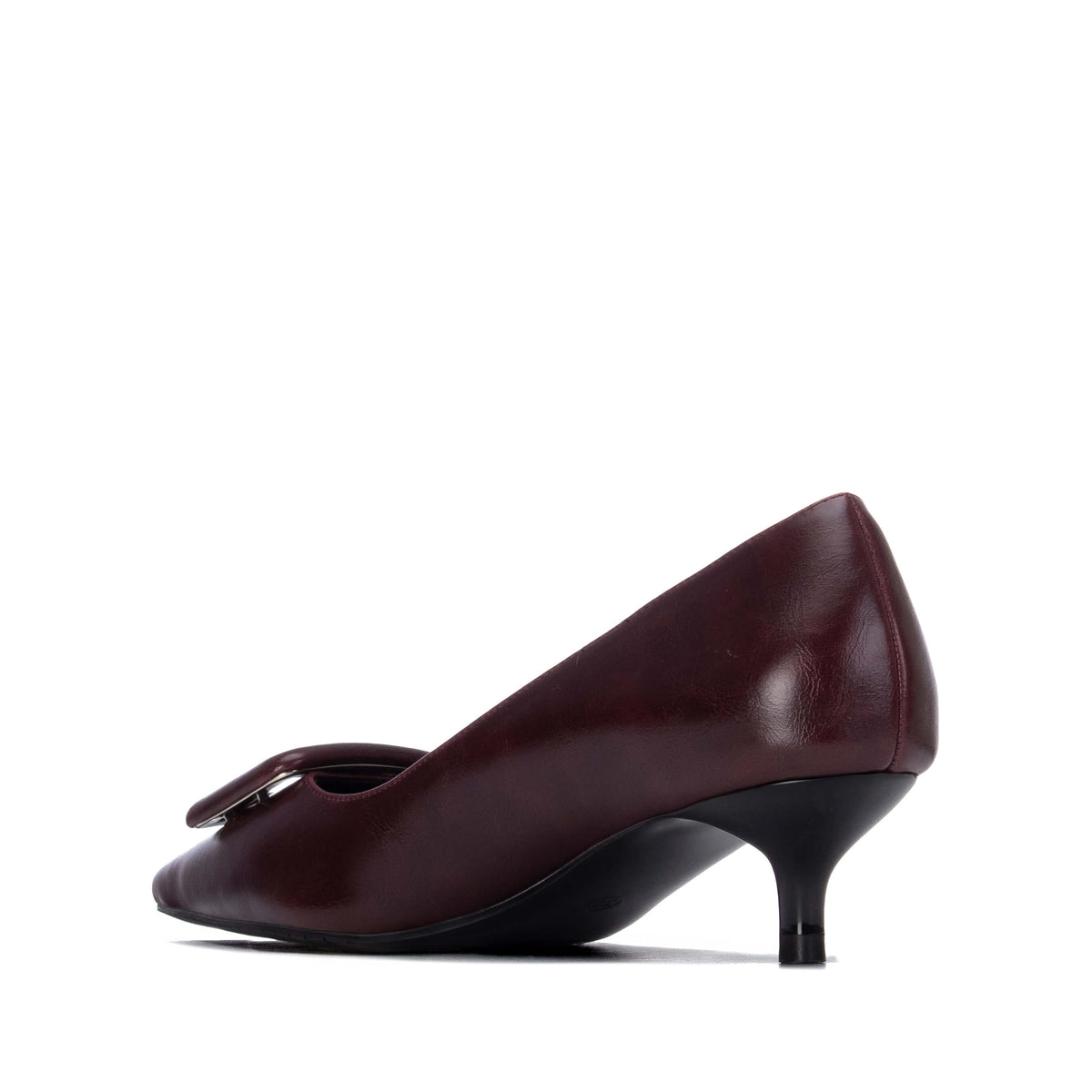 A single women's pump shoe in deep burgundy with a kitten heel and a decorative detail on the toe.