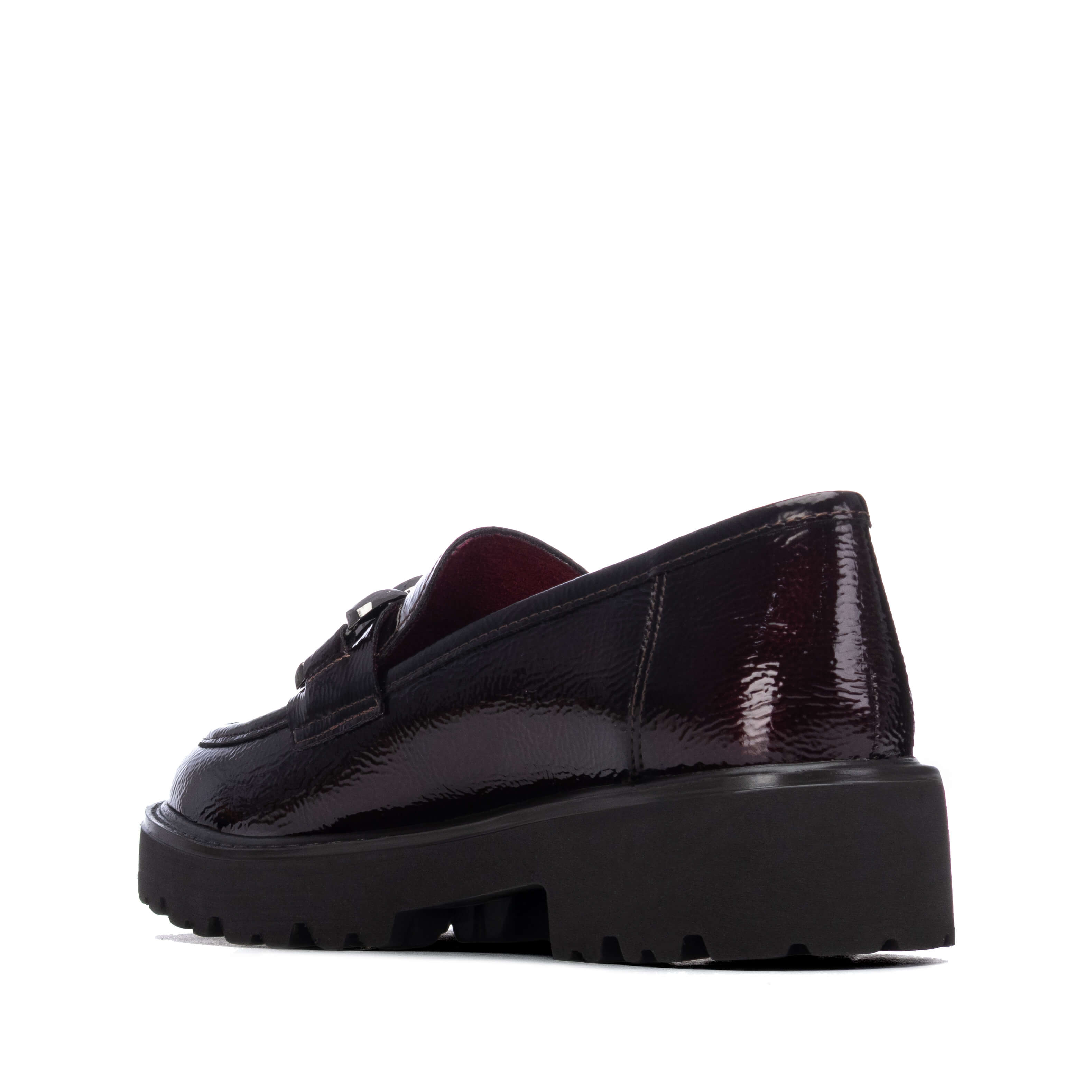A single dark plum patent loafer with a chunky black platform sole.